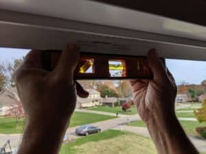 man performing leveling test on new window